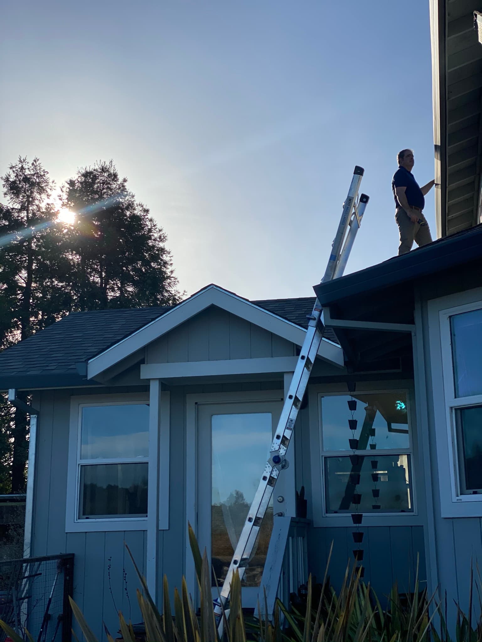 Juan de la Cruz inspecting a roof, as he does on Rohnert Park homes