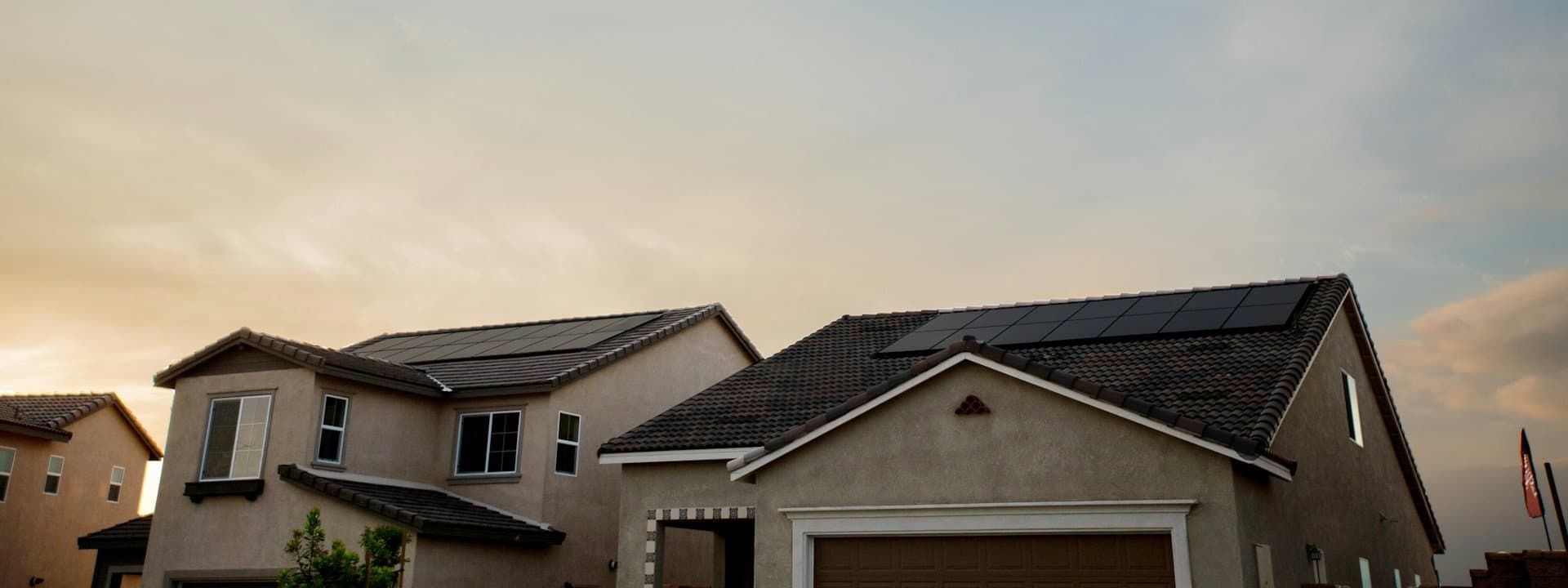 Homes with rooftop solar panels at dusk